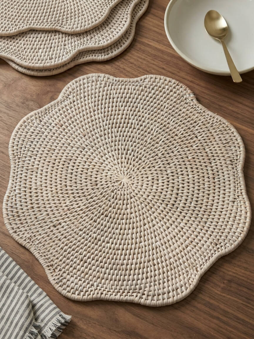 Ayre white scalloped rattan placemat styled on wooden dining table with neutral tableware
