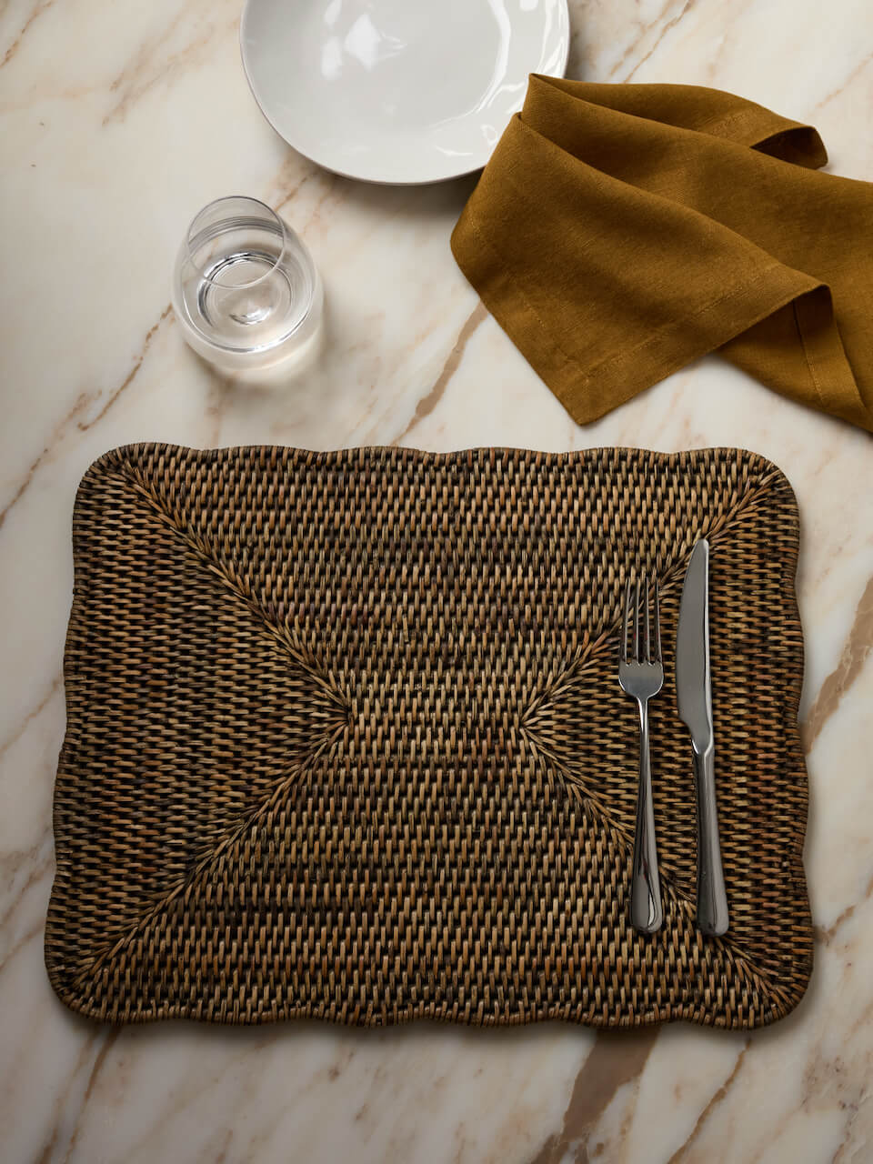 Antique brown rattan scalloped placemat rectangular, Ceres woven table mat styled with cutlery on marble dining table neutral home decor UK