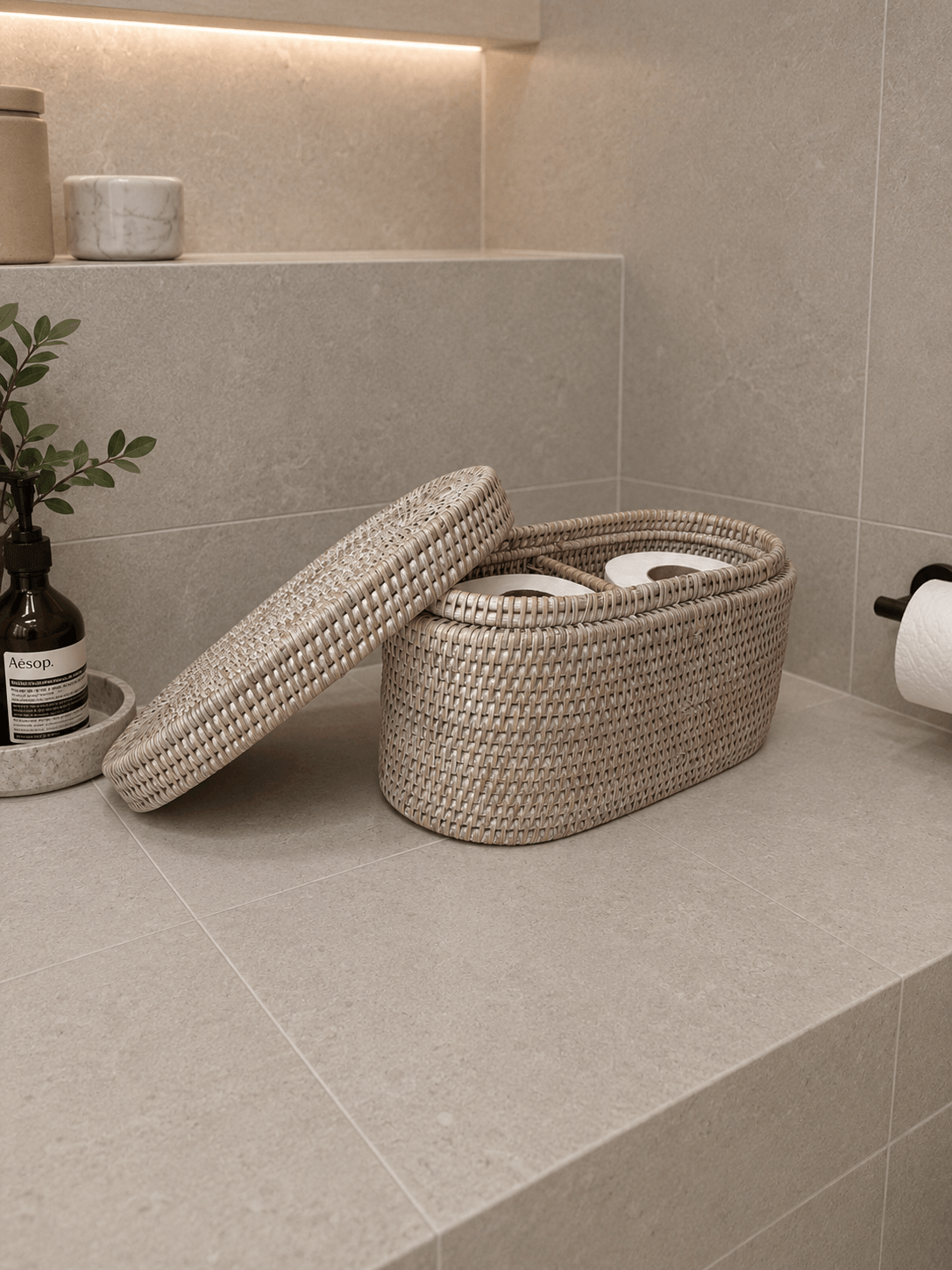 Jarra lidded basket with a lid on a tiled bathroom floor