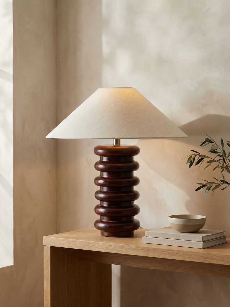 Uri wooden table lamp on a console with a ceramic vase