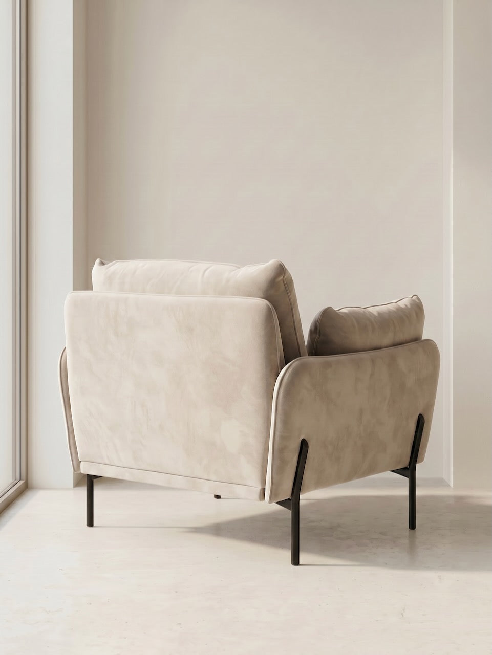 Beige armchair with a pillow in a minimalistic room.