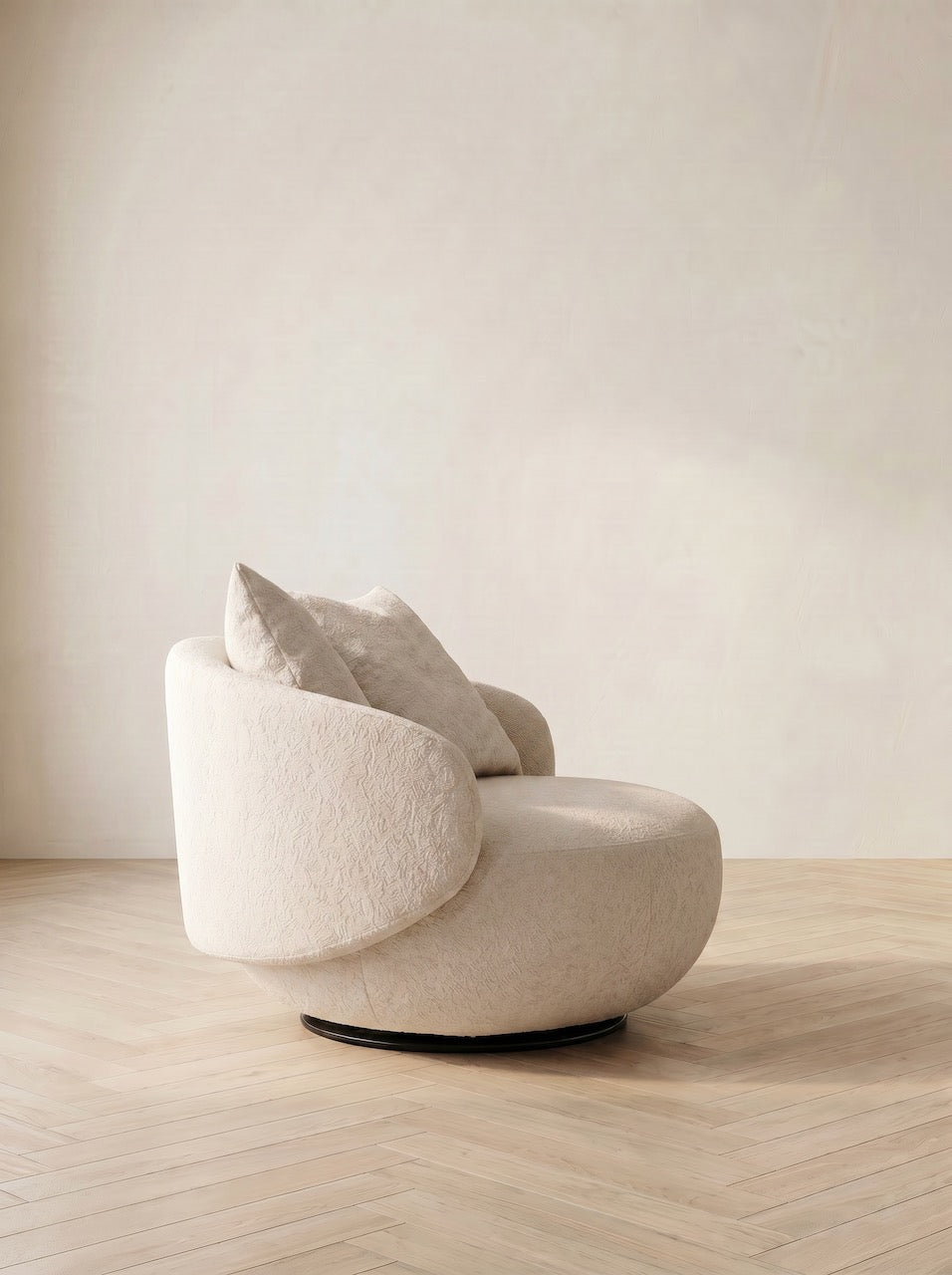 Modern beige armchair with cushions on a wooden floor and light-colored wall background