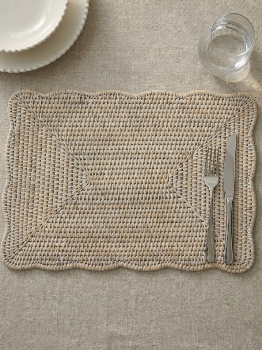 Ceres white rattan scallop placemat rectangular with cutlery on neutral linen table, woven placemat detail luxury table setting UK